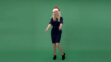 Young-blonde-woman-in-a-santa's-cap-showing-thumbs-up-and-smiling,-chroma-key-green-screen