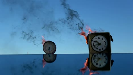 Time-is-a-fire.-Burning--old--alarm-clocks-on-mirror