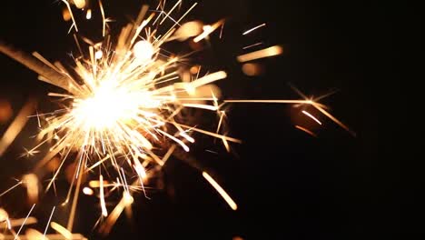Close-up-burning-of-Christmas-sparklers.-Fireworks-lit-on-black-background.
