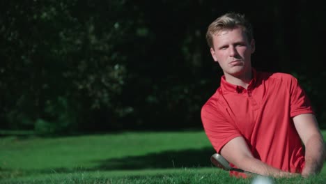 A-golfer-plays-a-slow-motion-shot-out-of-a-sand-trap.