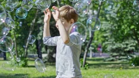 Lovely-Kids-Running-and-Catching-Bubbles-at-Warm-Sunny-Day