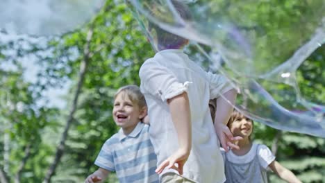 Beschwingt-Kinder-fangen-Bläschen-im-Park