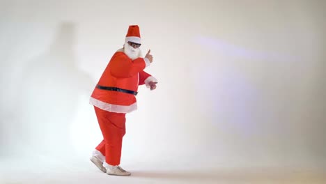 Funny-Santa-Claus-making-funny-dancing-dance-moves-on-a-white-background.-4K.