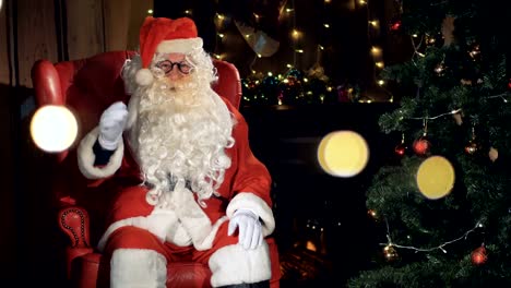 Cheerful-Santa-Claus-gesturing-at-a-christmas-fireplace.