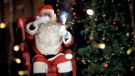 Santa-Claus-sitting,-dancing-near-fireplace-at-Christmas-night.