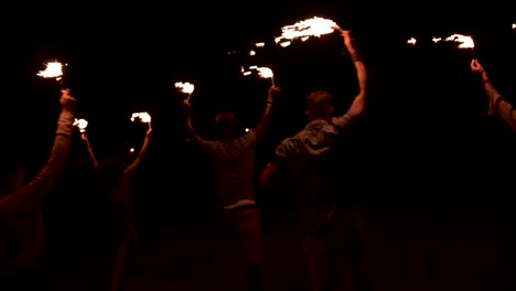 Young-multi-ethnic-hipster-friends-celebrating-at-outdoors-party-with-sparklers