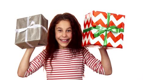 Happy-girl-holding-two-Christmas-gifts-in-her-hands