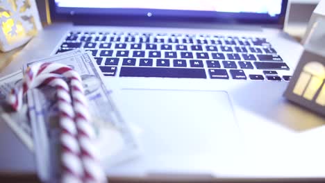 Opened-laptop-with-blinking-candles-on-table