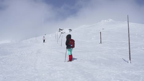 Girl-hiking-on-snow-in-Slovak-mountains-during-sunny-day-in-winter