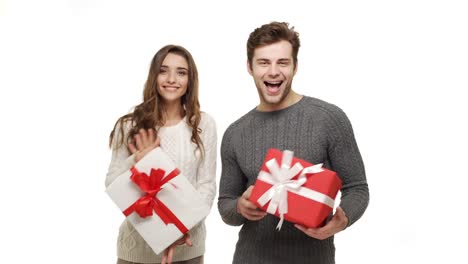 4k-Young-couple-showing-presents-in-Chrismas-day-on-white-background.
