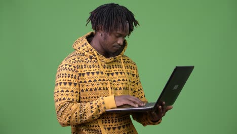 Young-handsome-African-man-using-laptop