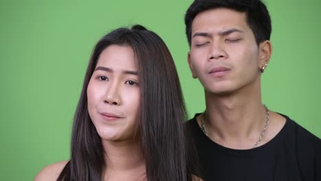 Young-Asian-couple-thinking-together-while-looking-worried