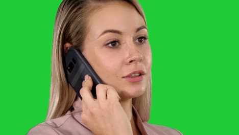 Face-of-young-cheerful-businesswoman-talking-on-mobile-phone-on-a-Green-Screen,-Chroma-Key