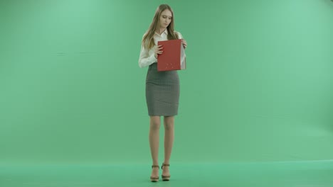 Business-woman-looking-folder-with-documents-on-green-screen