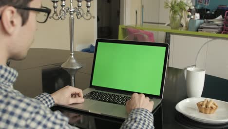 A-Man-Types-on-a-Laptop-on-His-Desk