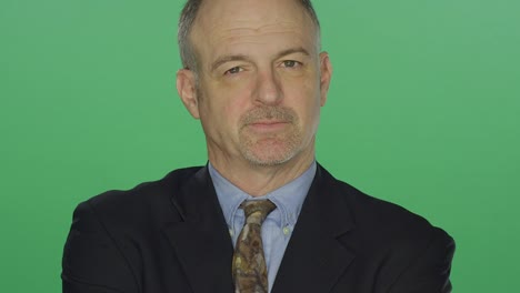 Middle-aged-businessman-looking-upset,-on-a-green-screen-studio-background