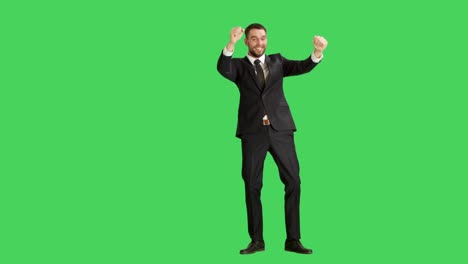 Long-Shot-of-a-Handsome-Smiling-Businessman-Dancing,-Making-Finger-Guns-Gesture-and-Having-Fun.-Background-is-Green-Screen.