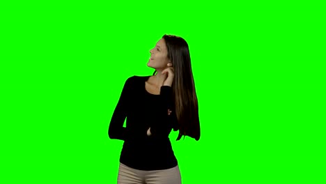 Smiling-woman-looking-around-against-green-screen