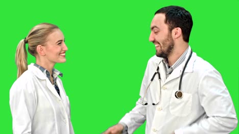 Young-doctor-joking-on-his-collegue-not-give-five-on-a-Green-Screen,-Chroma-Key