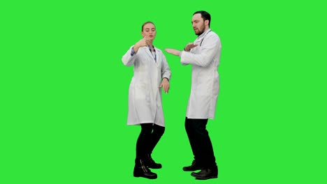 Two-funny-medical-doctors-with-funny-energy-dance-on-a-Green-Screen,-Chroma-Key