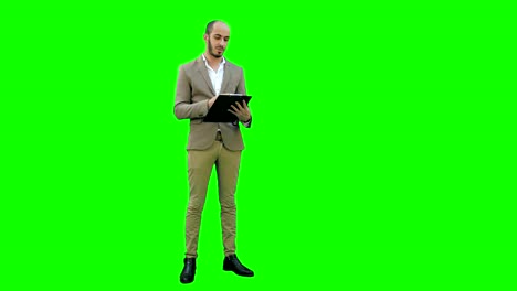 Manager-holding-clipboard-and-presenting-business-report-on-a-Green-Screen,-Chroma-Key