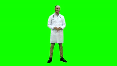 Smiling-doctor-happily-looking-at-the-camera-on-a-Green-Screen,-Chroma-Key