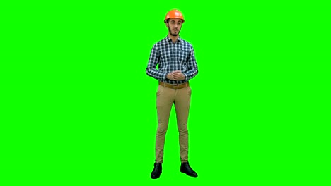 Construction-worker-enlisting-factors-for-success-on-his-fingers-on-a-Green-Screen,-Chroma-Key