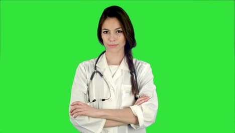 Attractive-young-female-doctor-in-white-coat-with-stethoscope-looking-into-the-camera-on-a-Green-Screen,-Chroma-Key