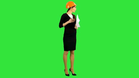 Angry-female-chief-engineer-with-documents-arguing-with-workers-on-a-Green-Screen,-Chroma-Key