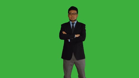 Young-Asian-Businessman-in-Front-of-a-Green-Screen.-Talking,-Turning-Around-and-Smiling.-Symbolizing-Growth,-Finance,-Bank,-Banker,-Success