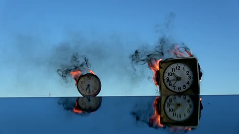Time-is-a-fire.-Burning--two-old--alarm-clocks-on-mirror