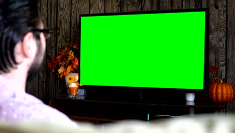 Angry-millennial-male-displeased-at-generic-sports-game-on-green-screen-TV