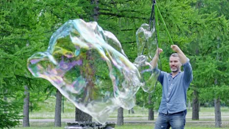 Joyous-Man-Blowing-Soap-Bubbles-with-Tri-Strings-Wand