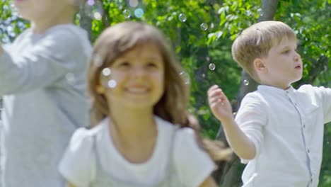 Kids-Catching-Soap-Bubbles-in-Park