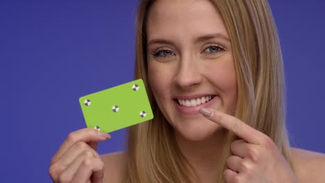 Close-Portrait-of-a-Woman-holding-a-blank-Credit-Card-and-making-thump-up