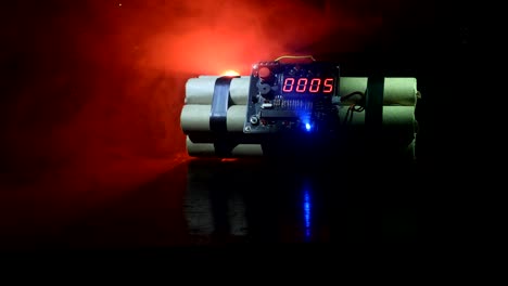 Time-bomb-against-dark-background.-Timer-counting-down-to-detonation-illuminated-in-a-shaft-light-shining-through-the-darkness.-Conceptual-footage
