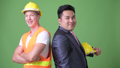 Scandinavian-man-construction-worker-and-Asian-businessman-working-together