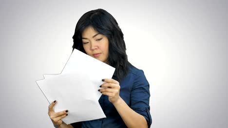 Asian-business-women-looking-document-file-in-her-hand-on-white-background