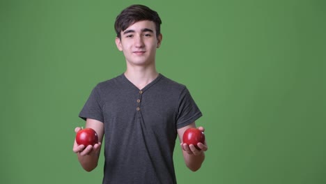 Young-handsome-Iranian-teenage-boy-against-green-background