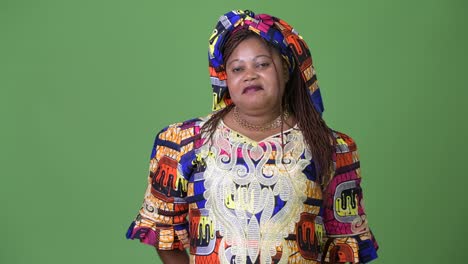 Overweight-beautiful-African-woman-wearing-traditional-clothing-against-green-background