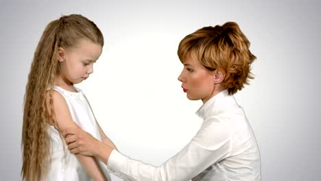 Mother-speaks-with-her-daughter-on-white-background