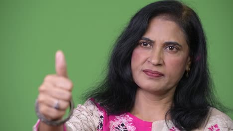 Close-up-shot-of-mature-beautiful-Indian-woman-giving-thumbs-up