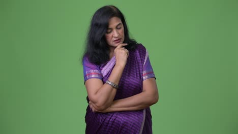 Mature-stressed-Indian-woman-thinking-while-wearing-Sari-traditional-clothes