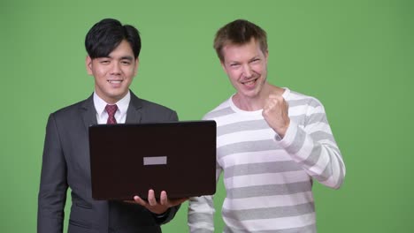 Young-handsome-Asian-businessman-and-young-Scandinavian-businessman-working-together