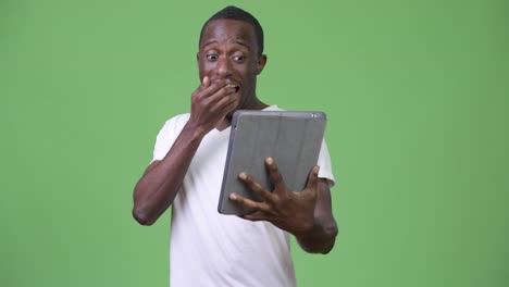 Young-shocked-African-man-using-digital-tablet