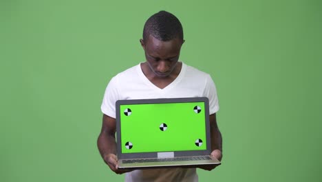 Young-African-man-showing-laptop