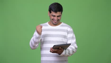 Young-handsome-Persian-man-using-digital-tablet