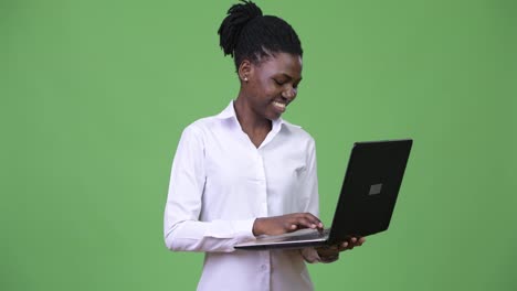 Young-beautiful-African-businesswoman-using-laptop