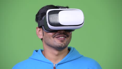 Young-handsome-Persian-man-using-virtual-reality-headset