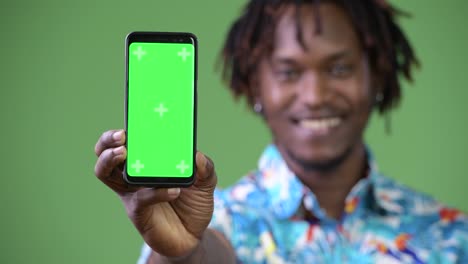 Young-handsome-African-tourist-man-showing-smart-phone